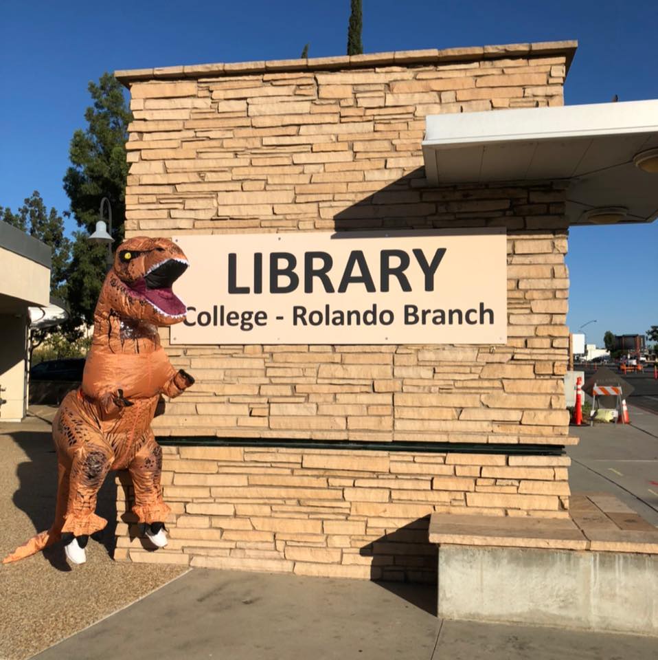 T-Rex costume character at the College-Rolando Branch